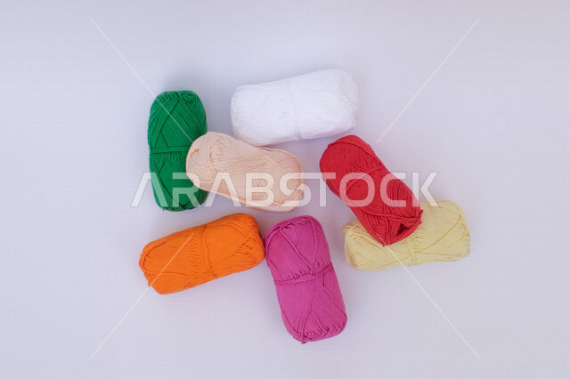 A set of sewing bobbins in many colors, knitting, sewing and embroidery skill, sewing bobbins, wool threads, crafts, white background
