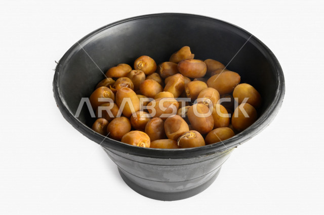 Yellow dates from the palms of the Kingdom of Saudi Arabia, palm harvesting in the farms of the Kingdom, Khalas dates, luxurious royal dates on a white background