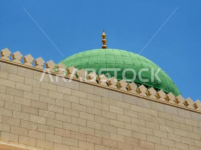 The exterior and the green dome of The Prophet's Mosque or Al Masjid Al Nabawi, a major site of pilgrimage that falls under the purview of the Custodi