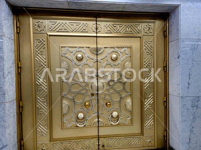 The golden door from the Sacred grand mosque of Makkah, the Sacred mosque is the most significant mosque in Islam, encloses vicinity of the Kaaba, amo The golden door from the Sacred grand mosque of Makkah, the Sacred mosque is the most significant mosque in Islam, encloses vicinity of the Kaaba, amo
