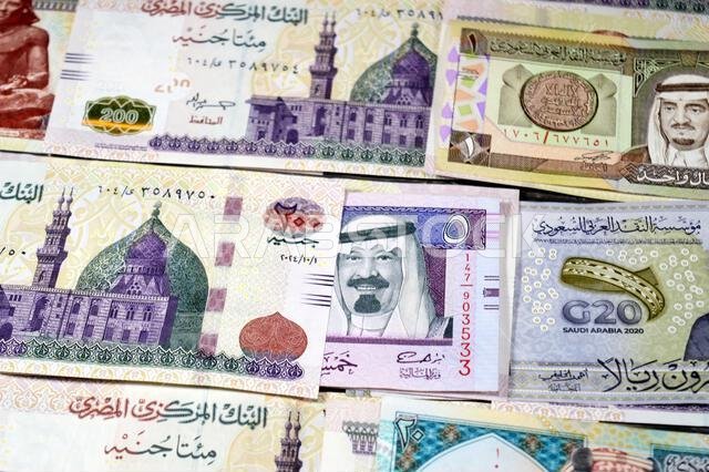Saudi Arabia riyals SAR cash money bills banknotes and Piles of Egypt money thousands of Pounds currency banknotes bills of 200 EGP LE, Egyptian money Saudi Arabia riyals SAR cash money bills banknotes and Piles of Egypt money thousands of Pounds currency banknotes bills of 200 EGP LE, Egyptian money