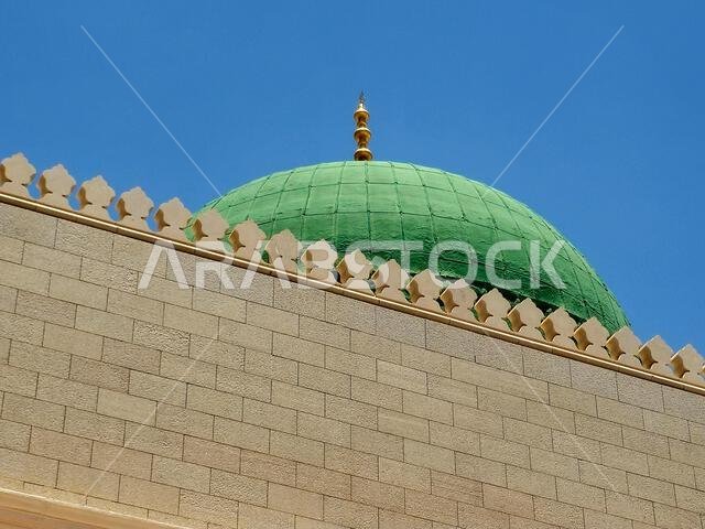 The exterior and the green dome of The Prophet's Mosque or Al Masjid Al Nabawi, a major site of pilgrimage that falls under the purview of the Custodi