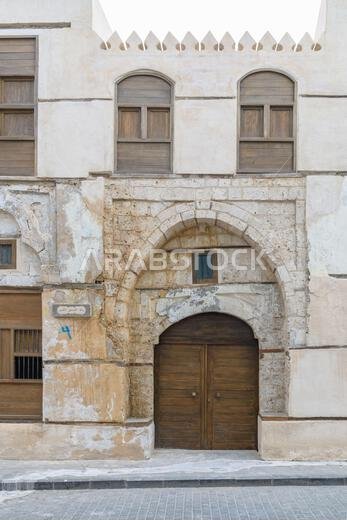 Jeddah, Saudi Arabia - December 21, 2022: Facade detail of historic Rubat Al-Khunji building in Al-Balad, featuring traditional Hejazi windows and roo