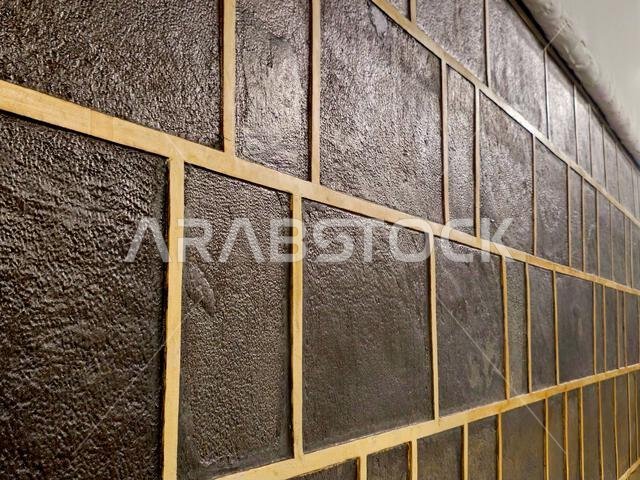 A closeup of The Kaaba, a stone building at the center of Islam's most important mosque and holiest site, the Masjid al-Haram, It's the Qibla, The dir