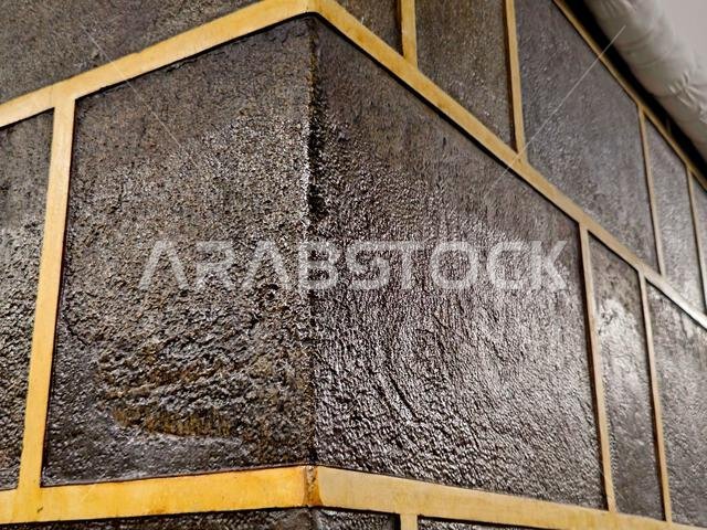 A closeup of The Kaaba, a stone building at the center of Islam's most important mosque and holiest site, the Masjid al-Haram, It's the Qibla, The dir A closeup of The Kaaba, a stone building at the center of Islam's most important mosque and holiest site, the Masjid al-Haram, It's the Qibla, The dir