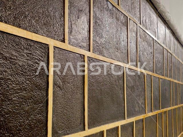 A closeup of The Kaaba, a stone building at the center of Islam's most important mosque and holiest site, the Masjid al-Haram, It's the Qibla, The dir