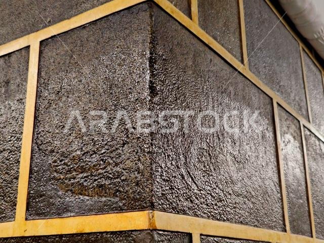 A closeup of The Kaaba, a stone building at the center of Islam's most important mosque and holiest site, the Masjid al-Haram, It's the Qibla, The dir A closeup of The Kaaba, a stone building at the center of Islam's most important mosque and holiest site, the Masjid al-Haram, It's the Qibla, The dir