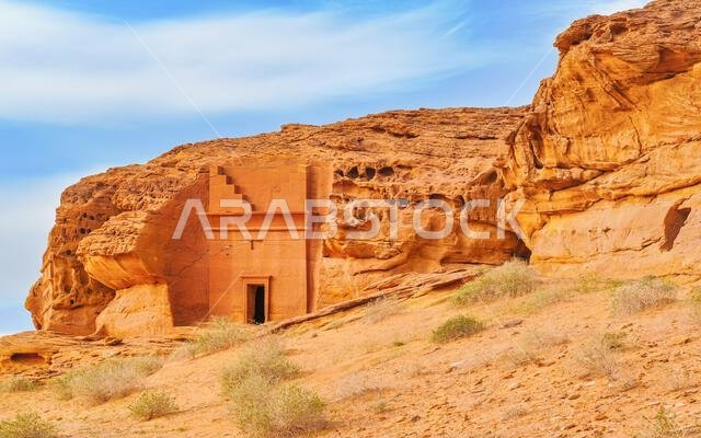 Old Nabatean architecture carved on orange sandstone wall at Jabal Al Ahmar, Hegra in Saudi Arabia, 18 ancient tombs are located here, 111 in whole Ma