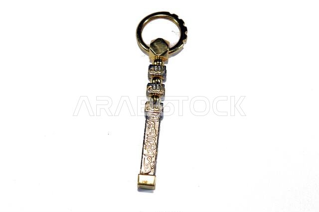 Translation of Arabic of Quran verse (Indeed, we have granted you a clear victory) and Allah word on a golden Kaaba Ka'bah key model, gold model of Ka Translation of Arabic of Quran verse (Indeed, we have granted you a clear victory) and Allah word on a golden Kaaba Ka'bah key model, gold model of Ka