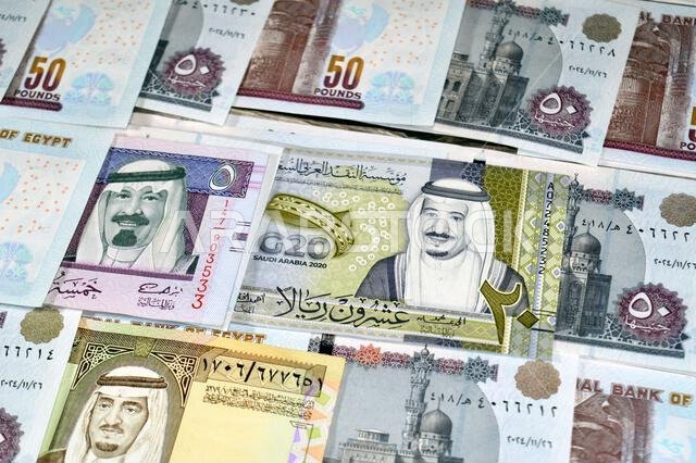 Saudi Arabia riyals SAR cash money bills banknotes and Pile of Egypt money hundreds of Pounds currency banknotes bills of 50 EGP LE, Egyptian money ex Saudi Arabia riyals SAR cash money bills banknotes and Pile of Egypt money hundreds of Pounds currency banknotes bills of 50 EGP LE, Egyptian money ex