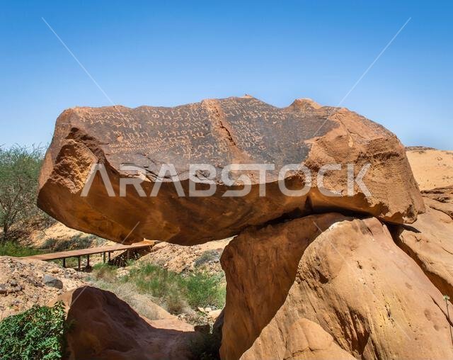 Alula, Saudi Arabia, April 4, 2024. View of the ancient Arabic scriptions on the rock at Jabal Ikmah Alula in a sunny day.