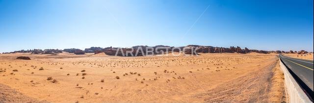 Drive on the beautiful scenic road between Riyadh and AlUla, through a landscape of sand desert, rock formations and mountains, in Saudi Arabia