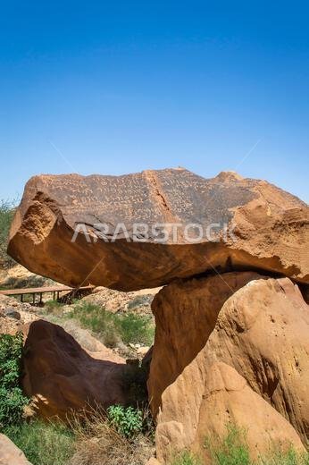 Alula, Saudi Arabia, April 4, 2024. View of the ancient Arabic scriptions on the rock at Jabal Ikmah Alula in a sunny day.