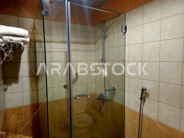 shower is a place in which a person bathes under a spray of typically warm or hot water, with a drain in the floor, a shower cabin stall with a glass shower is a place in which a person bathes under a spray of typically warm or hot water, with a drain in the floor, a shower cabin stall with a glass