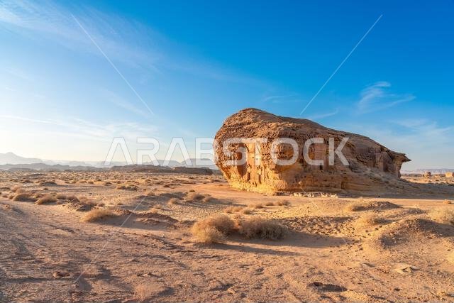 Jabal AlAhmar, carved sandstone rock at sunset, ancient tombs of Hegra, desert of AlUla, Saudi Arabia, breathtaking natural and archaeological wonder