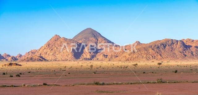 Drive on the beautiful scenic road between Riyadh and AlUla, through a landscape of sand desert, rock formations and mountains, in Saudi Arabia