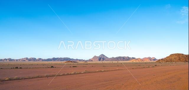 Drive on the beautiful scenic road between Riyadh and AlUla, through a landscape of sand desert, rock formations and mountains, in Saudi Arabia