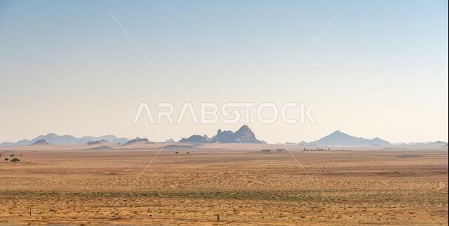 Drive on the beautiful scenic road between Riyadh and AlUla, through a landscape of sand desert, rock formations and mountains, in Saudi Arabia