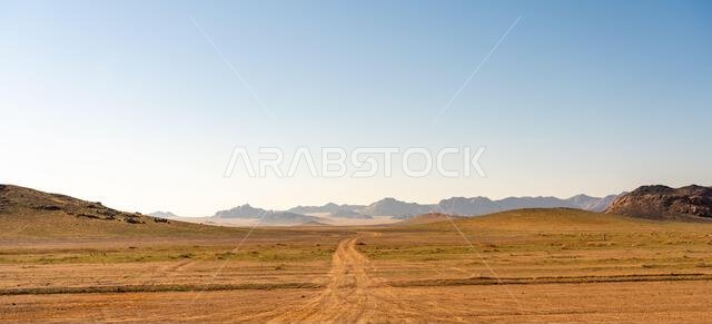 Drive on the beautiful scenic road between Riyadh and AlUla, through a landscape of sand desert, rock formations and mountains, in Saudi Arabia