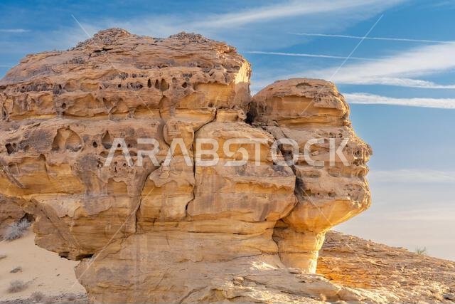 Face Rock at sunset, natural wonder near the carved sandstone rock of Jabal AlAhmar, the ancient tombs of Hegra in desert of AlUla, Saudi Arabia