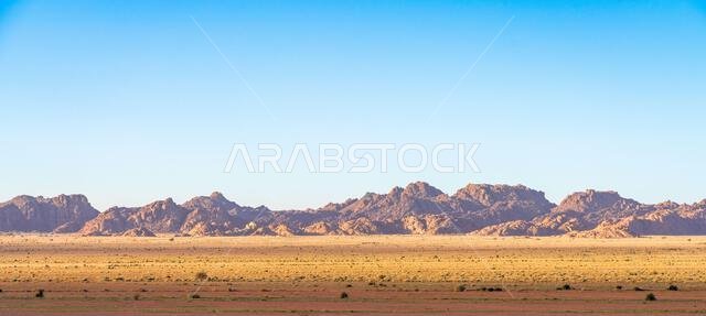 Drive on the beautiful scenic road between Riyadh and AlUla, through a landscape of sand desert, rock formations and mountains, in Saudi Arabia Drive on the beautiful scenic road between Riyadh and AlUla, through a landscape of sand desert, rock formations and mountains, in Saudi Arabia