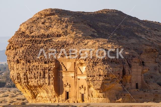 Jabal AlAhmar, carved sandstone rock at sunset, ancient tombs of Hegra, desert of AlUla, Saudi Arabia, breathtaking natural and archaeological wonder