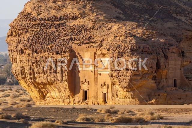 Jabal AlAhmar, carved sandstone rock at sunset, ancient tombs of Hegra, desert of AlUla, Saudi Arabia, breathtaking natural and archaeological wonder
