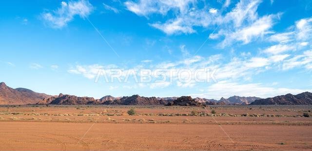 Drive on the beautiful scenic road between Riyadh and AlUla, through a landscape of sand desert, rock formations and mountains, in Saudi Arabia