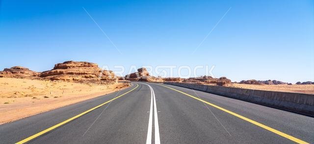 Drive on the beautiful scenic road between Riyadh and AlUla, through a landscape of sand desert, rock formations and mountains, in Saudi Arabia