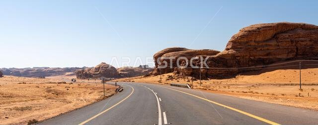 Drive on the beautiful scenic road between Riyadh and AlUla, through a landscape of sand desert, rock formations and mountains, in Saudi Arabia