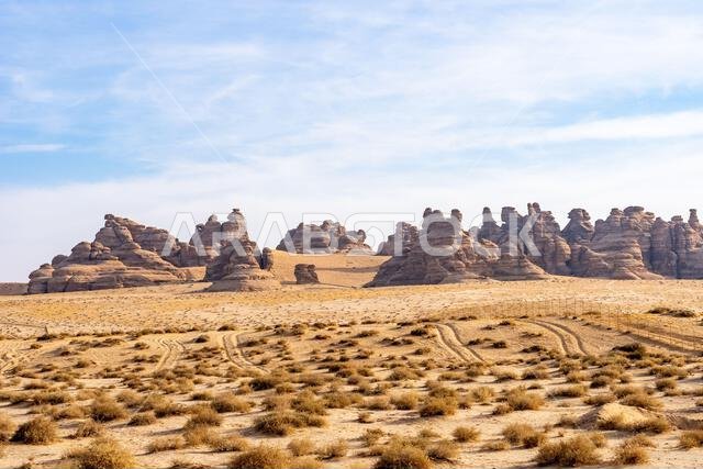 The scenic desert road between AlUla and Tabuk, Saudi Arabia, showcases amazing sandstone rock formations and a panorama with breathtaking landscape