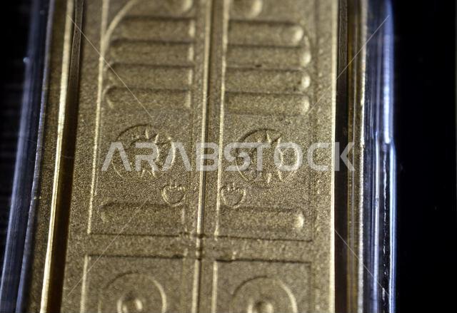The shape of the golden door of the holy Kaaba that is made of gold on 24K karat pure yellow gold bar, gold investment, exchange price rate, inflation