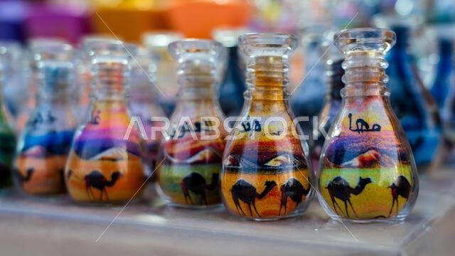 Doha, Qatar, January 24, 2025: A glass bottle filled with vibrant layers of sand forming intricate patterns, showcasing artistic precision and cultura