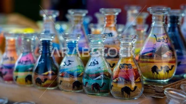 Doha, Qatar, January 24, 2025: A glass bottle filled with vibrant layers of sand forming intricate patterns, showcasing artistic precision and cultura