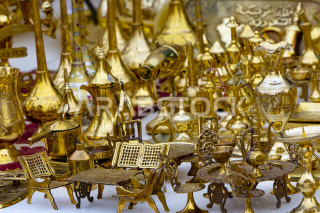 A group of ancient oriental Arab coffee pots and utensils made of copper in a traditional style, Saudi heritage, antique copper pieces in one of the museums of the Kingdom of Saudi Arabia