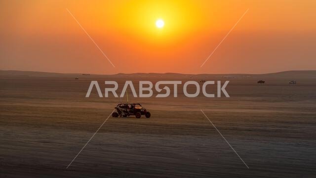 Doha, Qatar-January 22, 2025: A thrilling dune-bashing experience in the Sealine Desert, with off-road vehicles speeding across the golden sand dunes