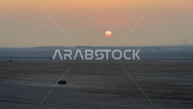Doha, Qatar-January 22, 2025: A thrilling dune-bashing experience in the Sealine Desert, with off-road vehicles speeding across the golden sand dunes