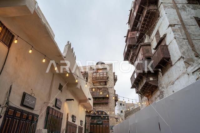 Jeddah, Saudi Arabia - December 20, 2024: At sunset the Qabel Trail in Al Balad district of Jeddah, Saudi Arabia, comes alive. The shops inviting visi