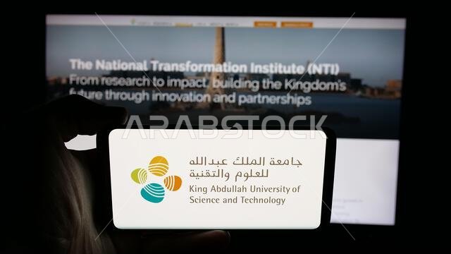 Stuttgart, Germany - 06-14-2025: Person holding cellphone with logo of Saudi King Abdullah University (KAUST) on screen in front of webpage.