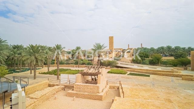 Panoramic view of Diriyah, a historic city near Riyadh, Saudi Arabia, featuring traditional architecture, lush palm groves, and modern structures in a