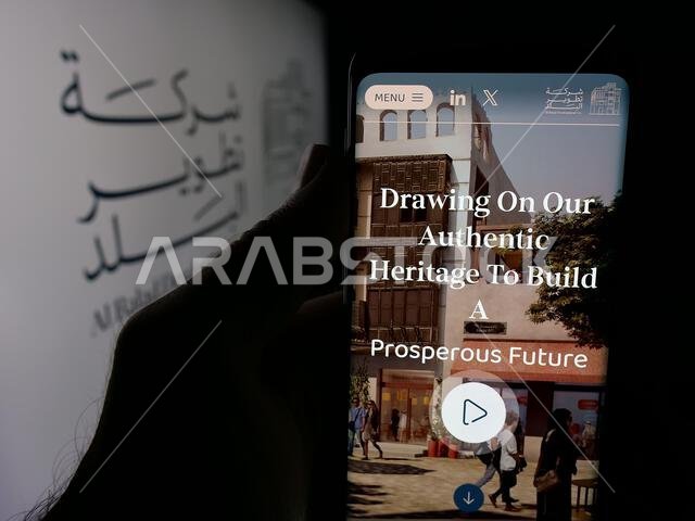 Stuttgart, Germany - 06-14-2025: Person holding cellphone with webpage of business Al Balad Development Company (BDC) on screen in front of logo. Stuttgart, Germany - 06-14-2025: Person holding cellphone with webpage of business Al Balad Development Company (BDC) on screen in front of logo.