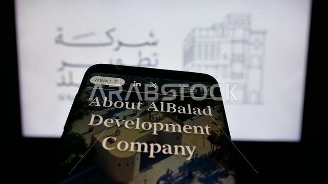 Stuttgart, Germany - 06-14-2025: Mobile phone with website of business Al Balad Development Company (BDC) on screen in front of logo.