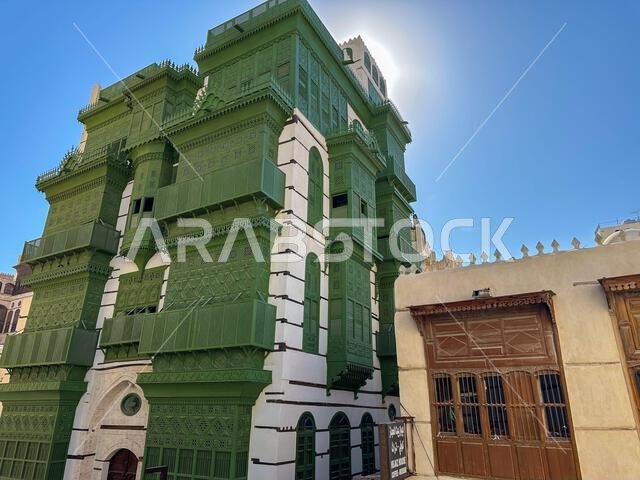 Traditional house with green wooden balconies, in the old town of Jeddah