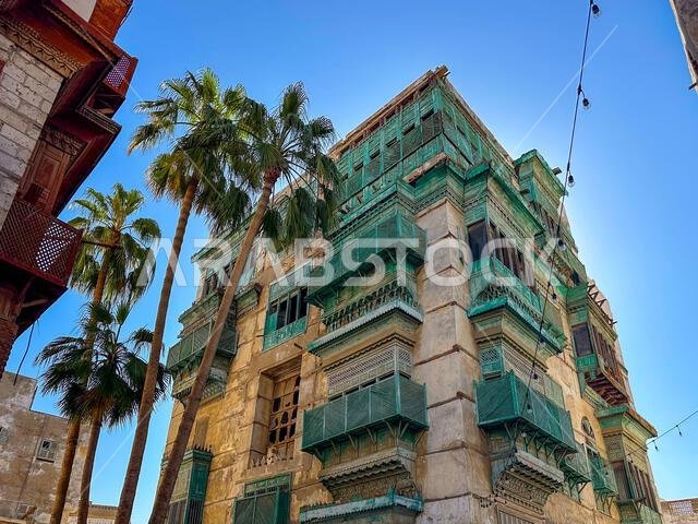 View from below of the houses in the old town of Jeddah with their ornate balconies.
