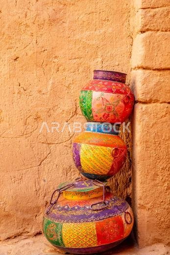 Three ornated traditional decorated arabic jars standing on each other on street of Al Ula, Medina province, Saudi Arabia