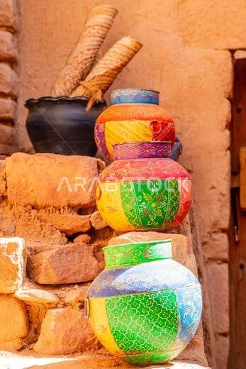 Three ornated traditional decorated arabic jars standing on street of Al Ula, Medina province, Saudi Arabia