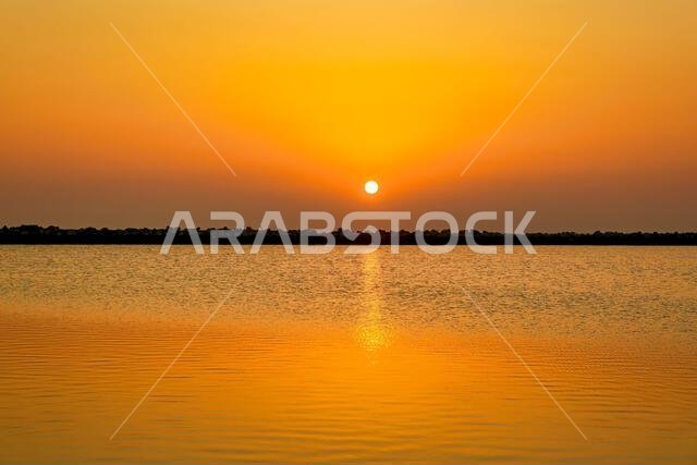 Morning Radiance: Witnessing the Sun's Arrival at Dammam Corniche, Saudi Arabia Morning Radiance: Witnessing the Sun's Arrival at Dammam Corniche, Saudi Arabia
