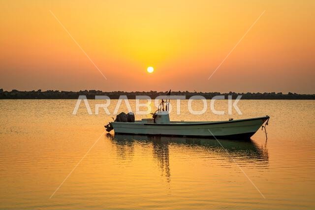 Golden Hour Majesty: Sunrise Silhouettes of Boats on Dammam Corniche, Saudi Arabia