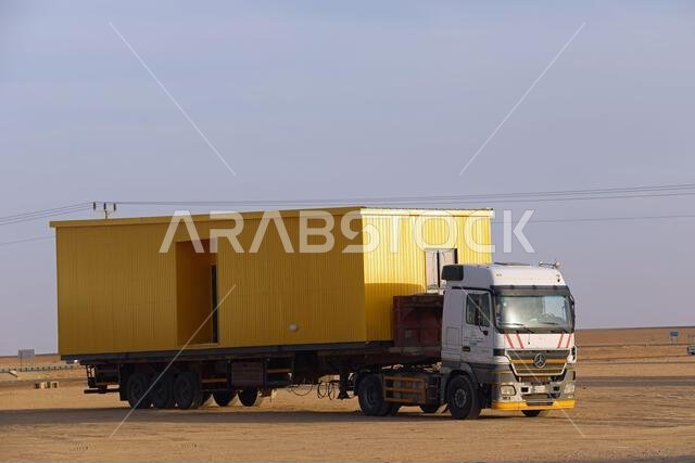 Prefabricated building being transported in Saudi Arabia