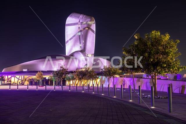 Illuminated modern building and square with trees in the center of Al Khobar, Saudi Arabia